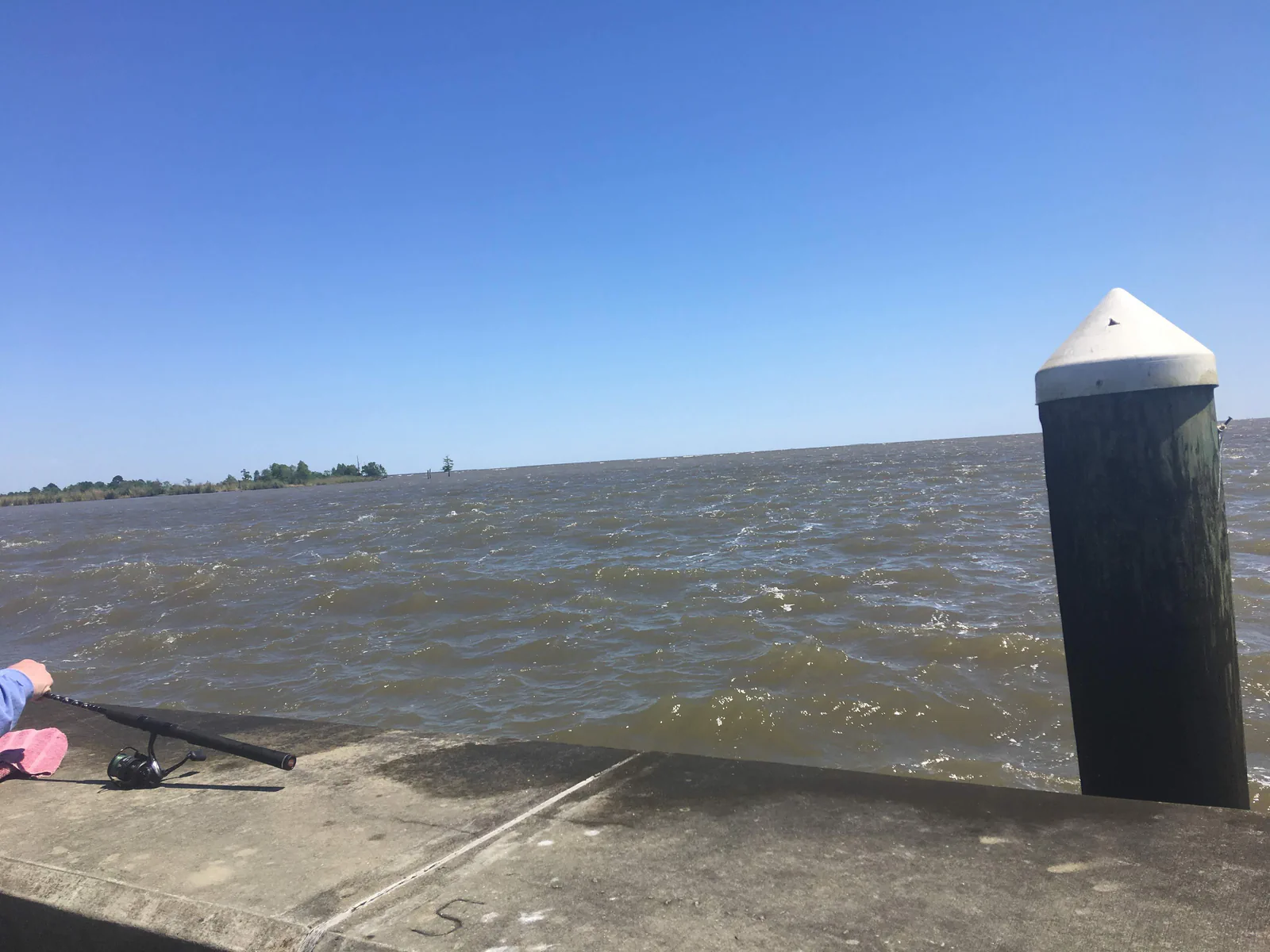 Choppy lower-coast open water beside dock structure in Southeast Louisiana