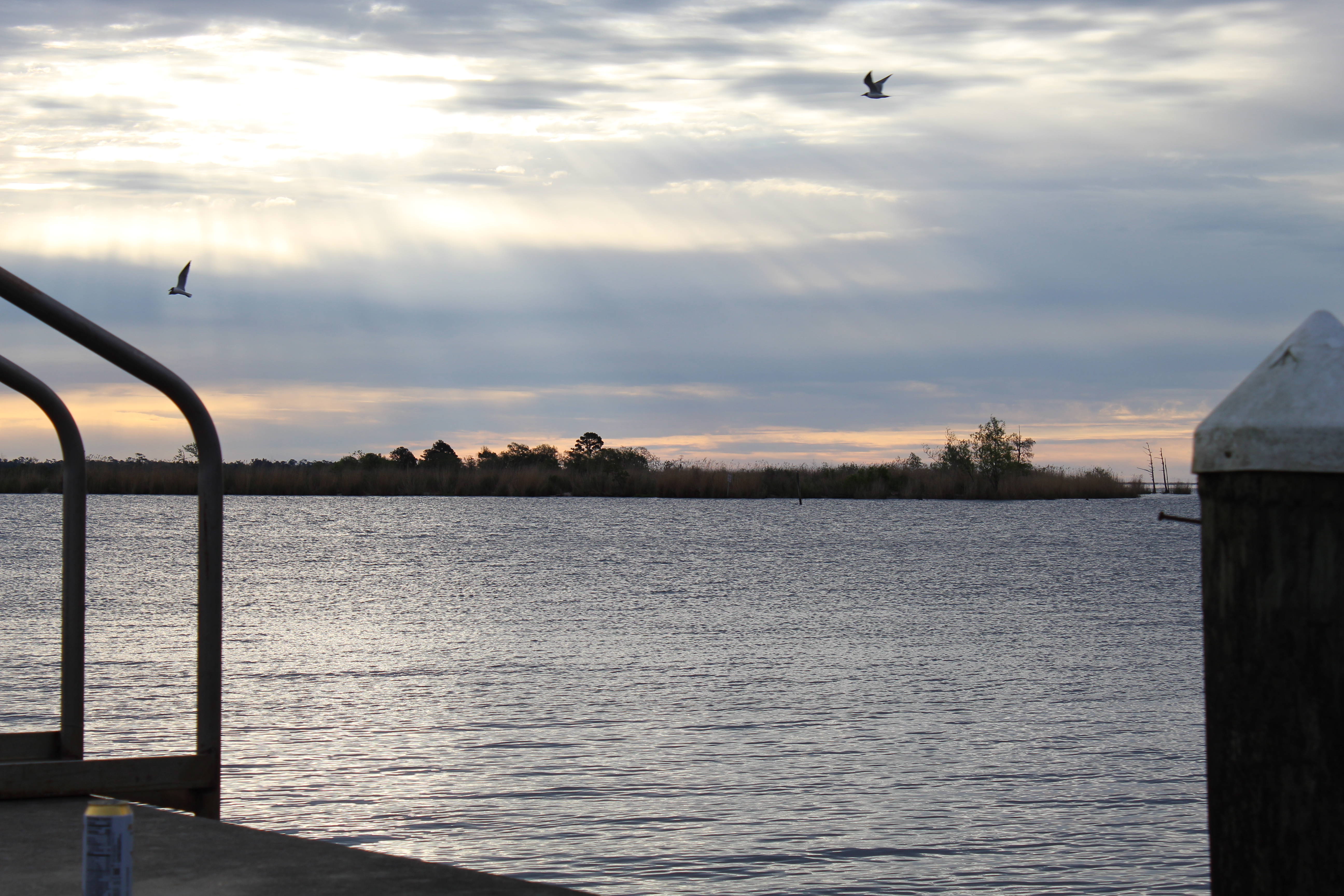 Open marsh water under a changing Southeast Louisiana sky